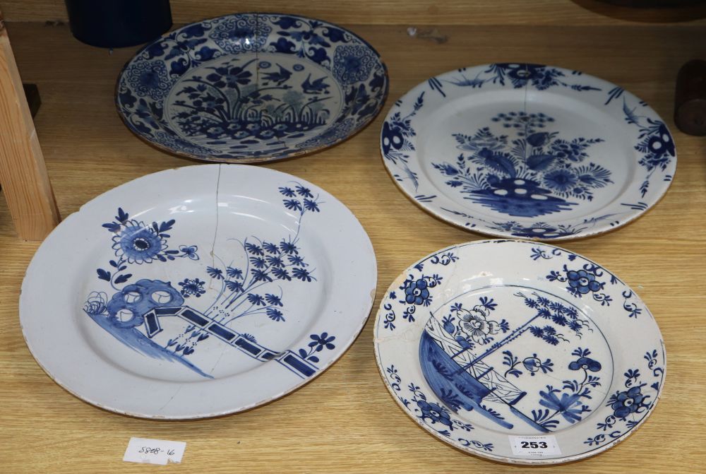 Four 18th century Delft blue and white dishes, largest 35cm (a.f.)